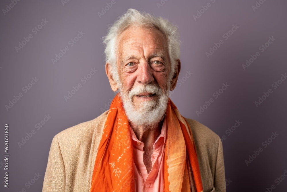 Portrait of a senior man in orange scarf on a purple background.