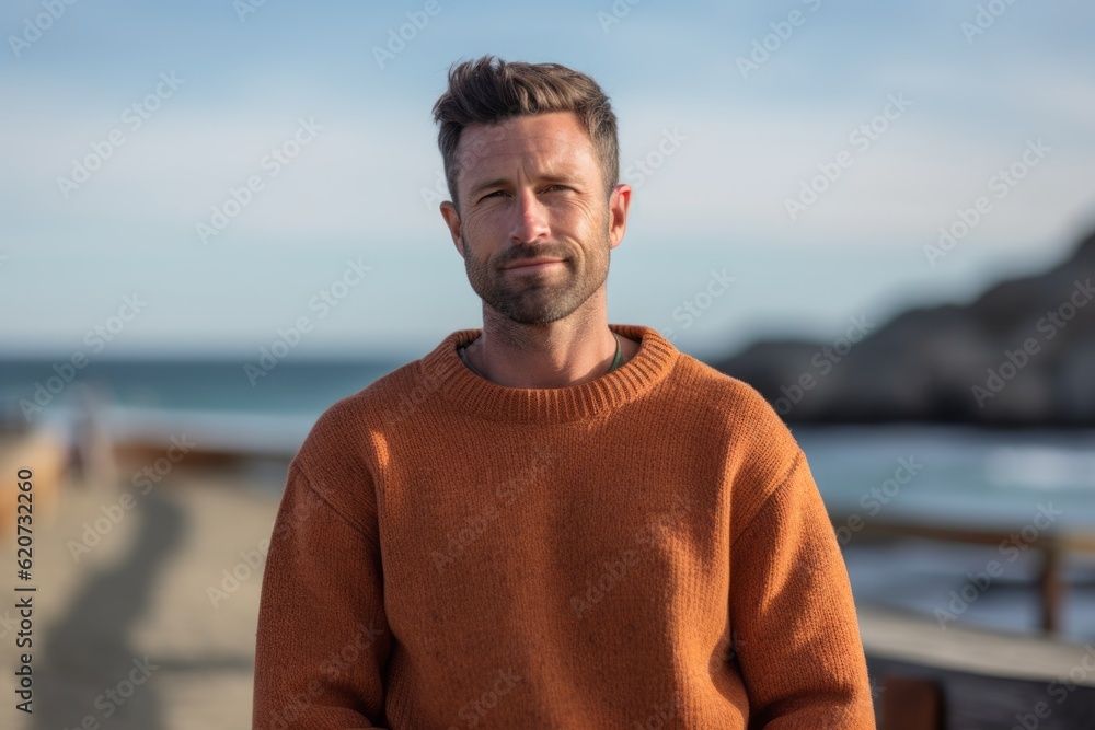 Portrait of a handsome man standing on the beach at autumn day Portrait of a handsome man standing on the beach at autumn day