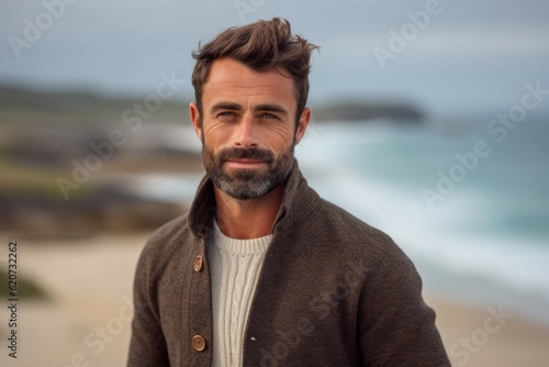 Portrait of a handsome man standing on the beach at the beach