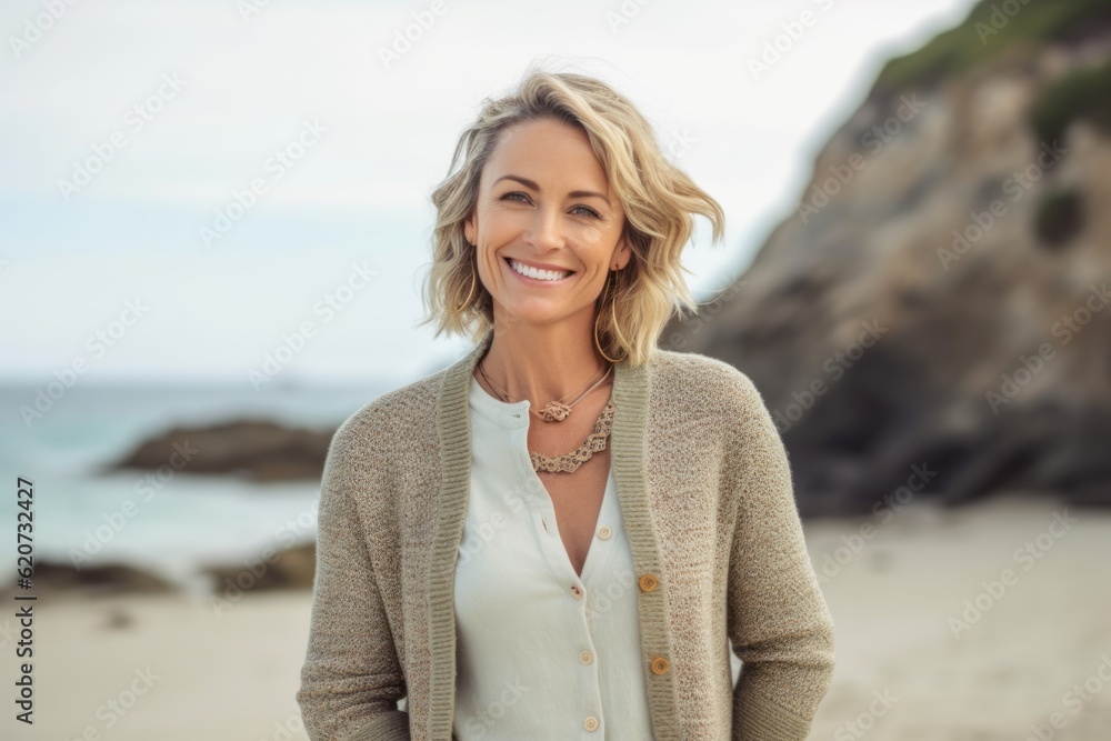 Portrait of smiling woman standing on beach with arms crossed on chest Portrait of smiling woman standing on beach with arms crossed on chest