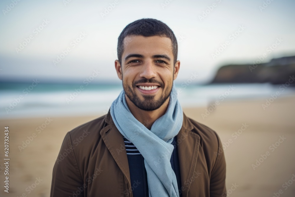 Portrait of smiling young man standing on beach at the day time Portrait of smiling young man standing on beach at the day time