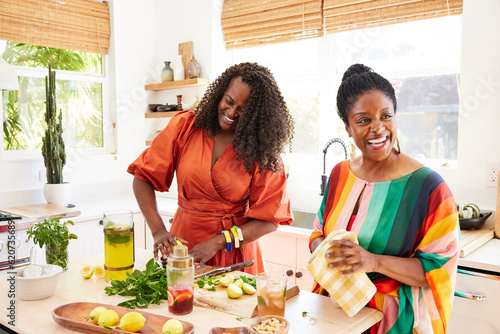 Black girlfriends cooking healthy meal together in the kitchen at home
