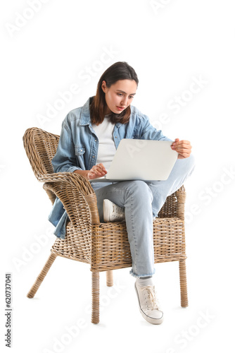 Young woman using laptop in...