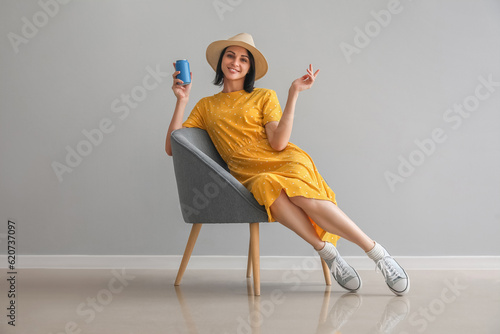 Beautiful woman with can of...