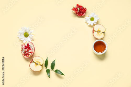 Composition with fresh apple, pomegranate, honey and flowers on color background. Rosh hashanah (Jewish New Year) celebration
