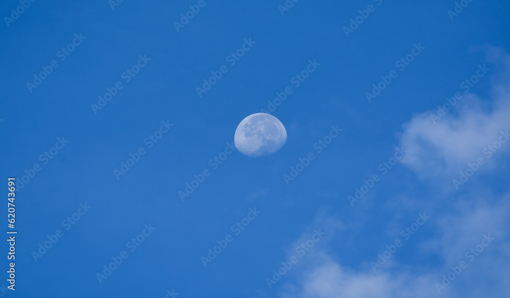 The moon is in the sky and clouds. The moon is in the sky and clouds.