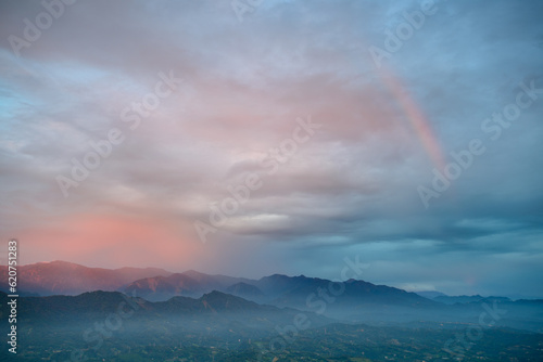 At dusk, the romantic red or orange sunset glow on the top of the mountain. At dusk, the scenery of the seaside in Miaoli County. © twabian