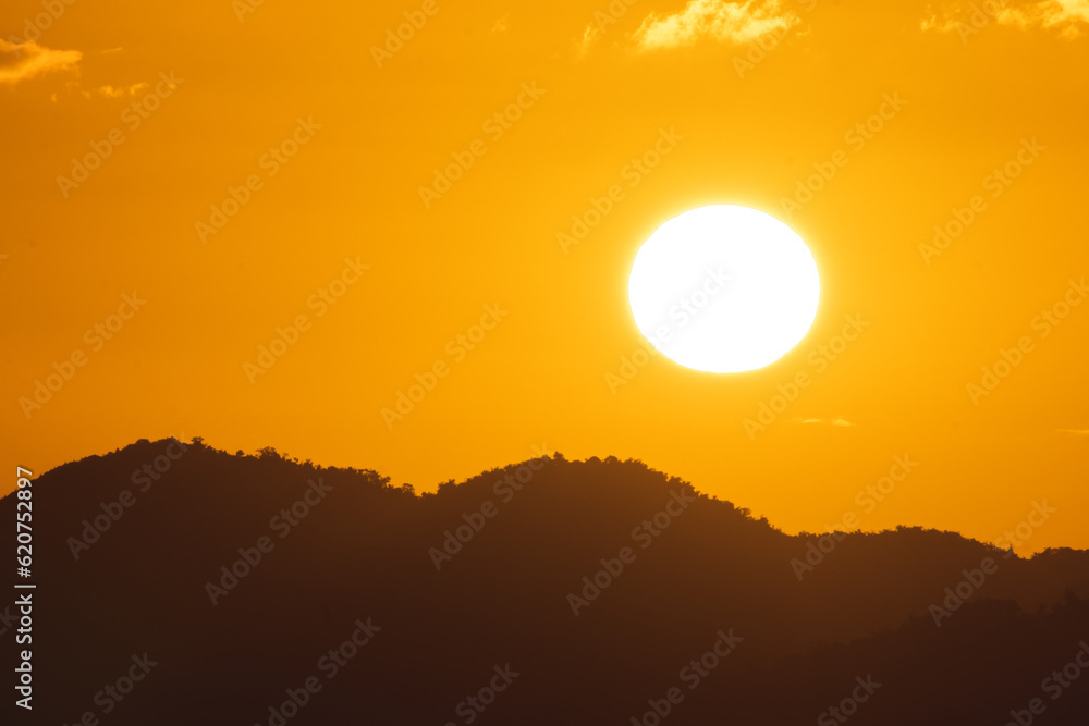Golden sunset landscape with the sun above the mountains from puerto rico Golden sunset landscape with the sun above the mountains from puerto rico