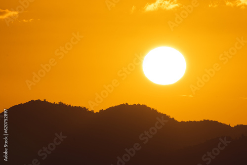 Fototapeta Naklejka Na Ścianę i Meble -  Golden sunset landscape with the sun above the mountains from puerto rico	