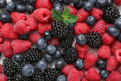 Fresh raspberry  blackberry and blueberry on light background  closeup