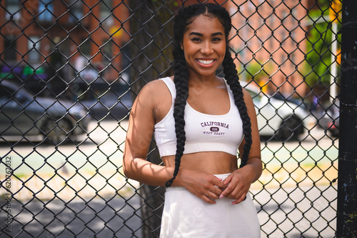 Fotografie Sporty Woman In Athletic Gear Traveling Around The City
