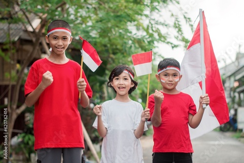 Indonesian kids boy and girl celebrate independence day at outdoor photo