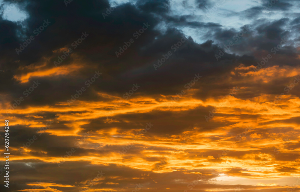Beautiful landscape of sunset with dark colorful fluffy clouds. Natural background.