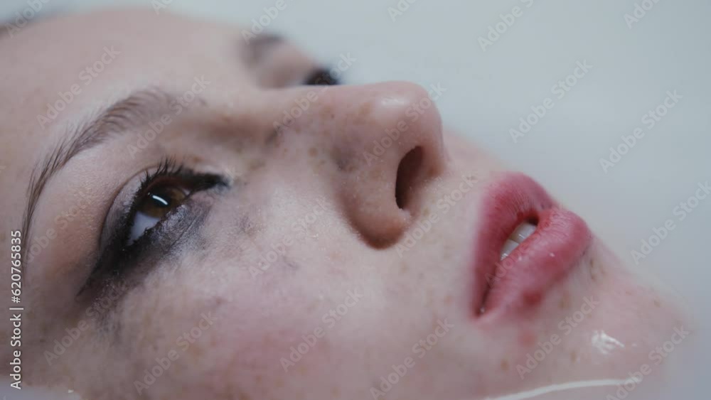 young lady who has been crying in a bubble bath with dripping mascara. young lady who has been crying in a bubble bath with dripping mascara.