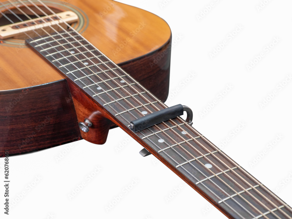 Obraz premium Capo on the Acoustic guitar neck , capro made from aluminium, Selective focus at capo, whtie background.