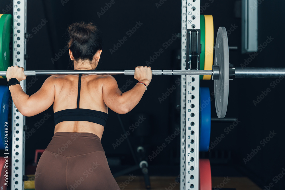 Fitness model performing weight lifting exercise at gym Fitness model performing weight lifting exercise at gym