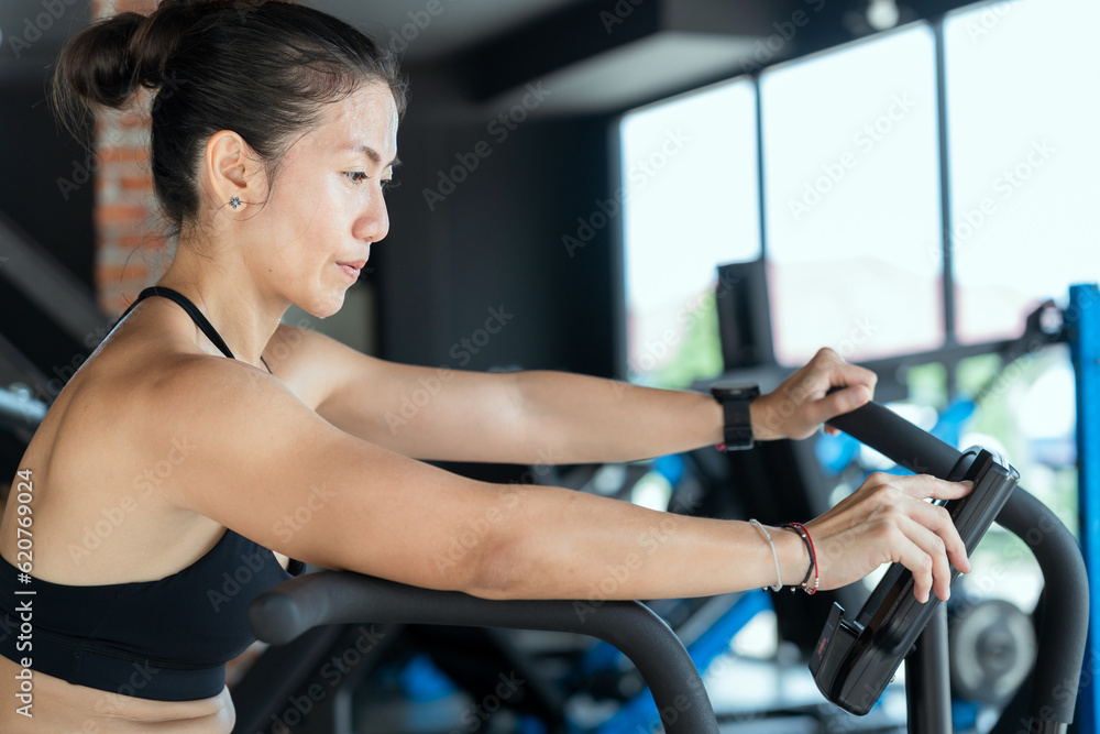 Fototapeta premium Asian beautiful sport woman exercise on treadmill machine gym is sport healthy body building in fitness lifestyle