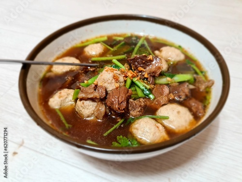 Thai khaolao is a dish of tender meat and vegetables cooked in broth or sauce, without noodles. It originated from a Chinese dish called gaolou, meaning skyscraper, which was the name of a famous rest