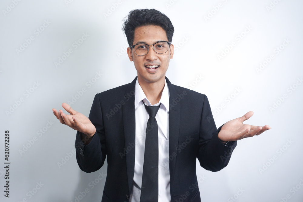 I don't know, who cares. Portrait of confused Asian man with in suit shrugging shoulders, making no idea gesture, whatever. indoor studio shot isolated on white background I don't know, who cares. Portrait of confused Asian man with in suit shrugging shoulders, making no idea gesture, whatever. indoor studio shot isolated on white background