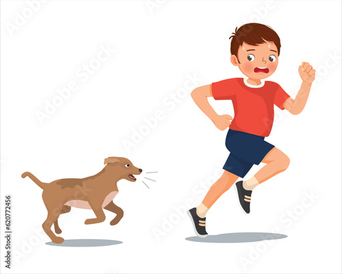 Cute little boy running scared chased by barking dog