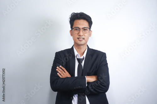 Portrait working Asian business handsome man ware suit standing arms crossed on white background with copy space - business concept