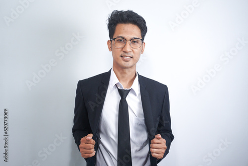 Portrait of handsome Asian young man in black suit