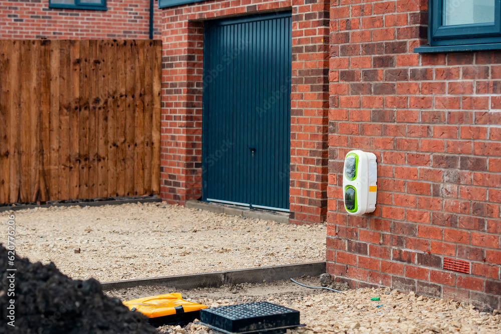 Electric vehicle domestic charging point installed outside of the house on new housing
