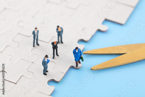 Miniature photography workplace layoffs puzzle scissors