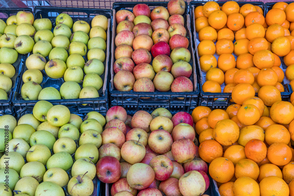 Apples and tangerines for sale at a market Apples and tangerines for sale at a market