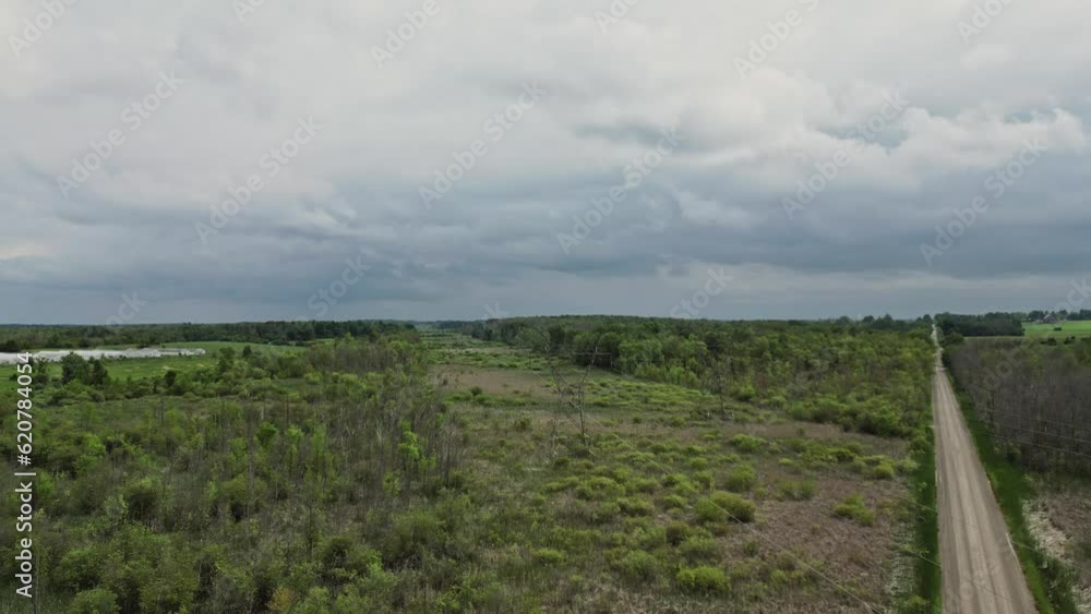 Remote Dirt Road Overcast Sky. Aerial Wide Shot Remote Dirt Road Overcast Sky. Aerial Wide Shot