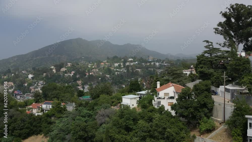 Gliding over Hollywood Hills on a misty morning towards the 101 Freeway with the Hollywood sign in the background Gliding over Hollywood Hills on a misty morning towards the 101 Freeway with the Hollywood sign in the background