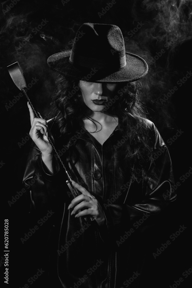 Fototapeta premium Sexy female dominant mistress with a whip flogger for BDSM sex with submission and domination