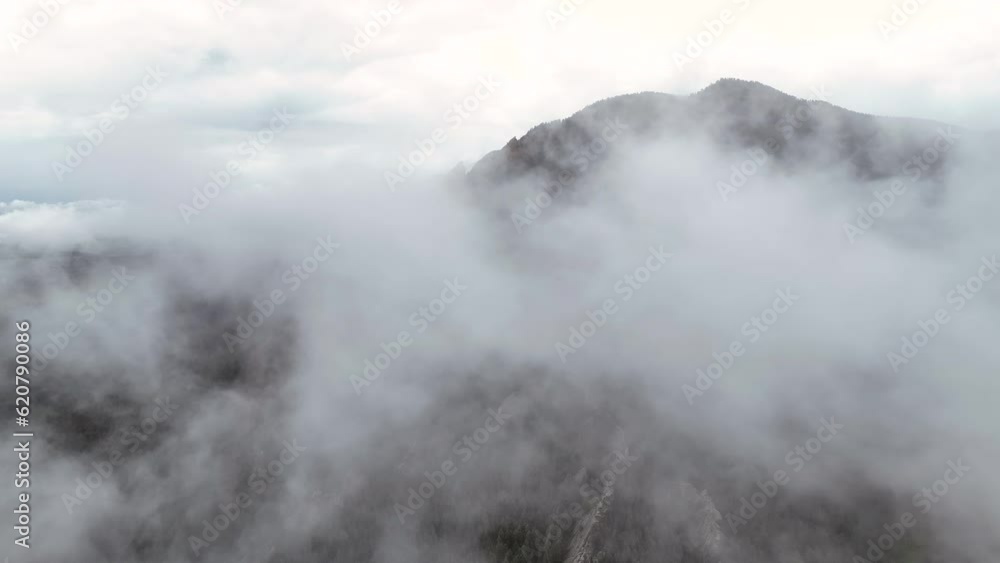 High angle aerial above thin clouds over iconic Flatirons in Boulder, Colorado High angle aerial above thin clouds over iconic Flatirons in Boulder, Colorado