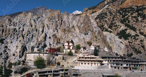Aerial View of Bhraka Monastery Annapurna region at Manang Nepal. Rocky dry Mountains surround the Monastery and inhabitants are seen. Calm and peace 4K