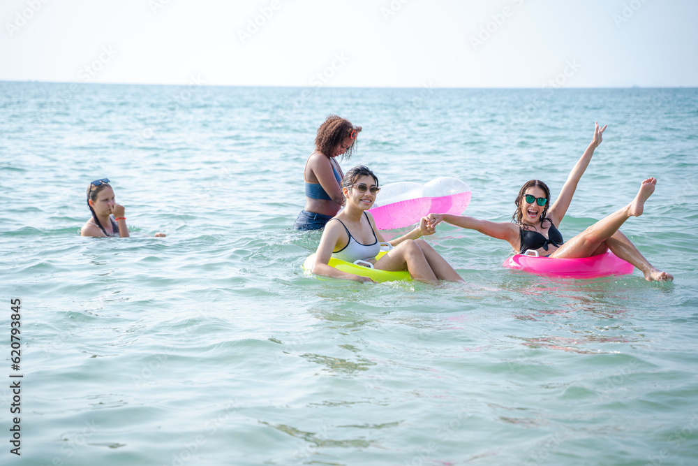 Group of friends having fun at ocean beach,Vacation on sea,Beach summer holiday sea people concept.