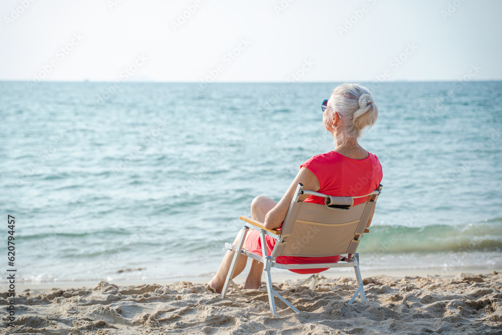 Happy senior woman spending time at the beach,Summer vacation.