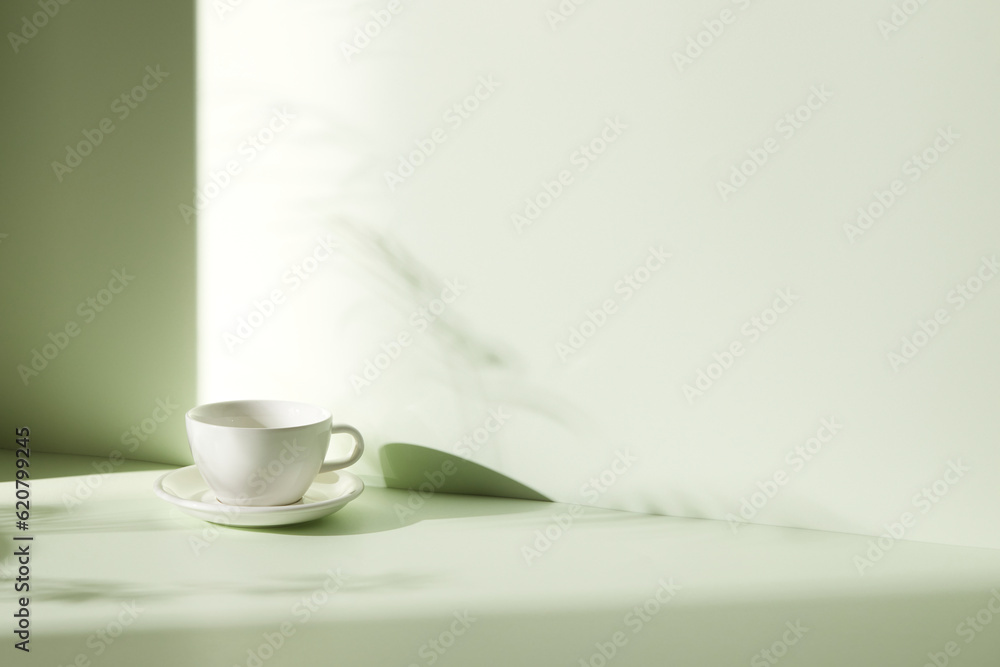 A room with various objects such as warm sunlight, shadows of grass leaves, a vase on a table, and cups A room with various objects such as warm sunlight, shadows of grass leaves, a vase on a table, and cups
