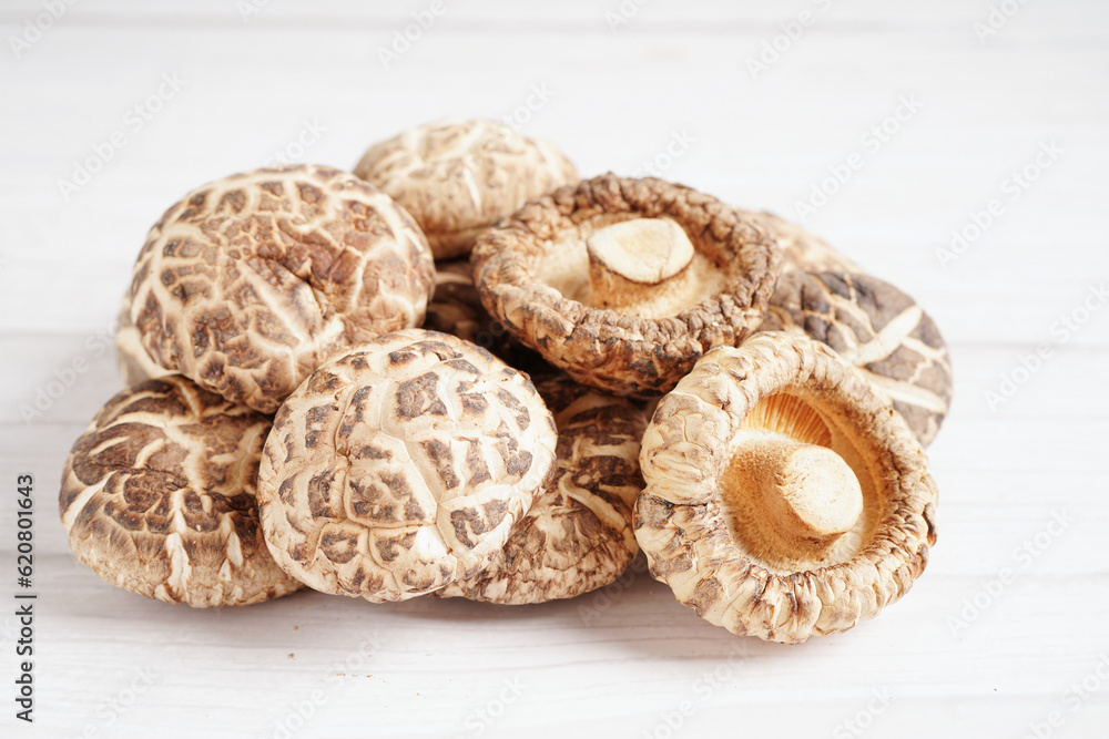 Dried shiitake mushroom on wooden background. healthy food.