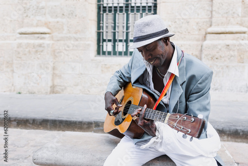Photography Black Man musician playing guitar on the street in La Havana in Latin America, A