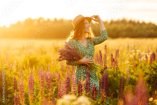 Young woman in lavender field on summer day. Nature, vacation, relax and lifestyle