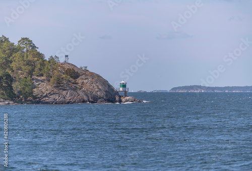 Island, skerries and islet, in the middle part of the archipelago. A ness with a lighthouse and open sea, a sunny summer day in Stockholm
