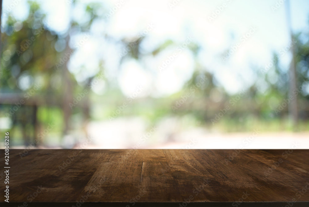 image of wooden table in front of abstract blurred background of outdoor garden lights. can be used for display or montage your products.Mock up for display of product. image of wooden table in front of abstract blurred background of outdoor garden lights. can be used for display or montage your products.Mock up for display of product.
