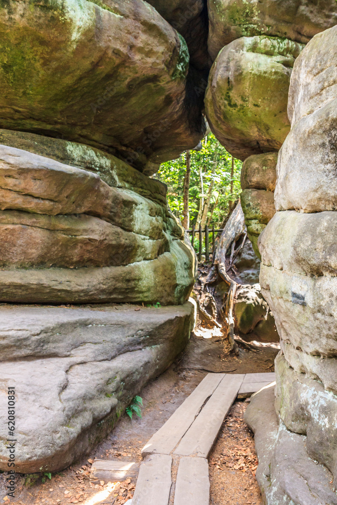 Tourist trail in Errant Rocks (Błędne Skały) through a picturesque labyrinth (rock city) in the Central Sudetes in the Stolowe Mountains (Poland)