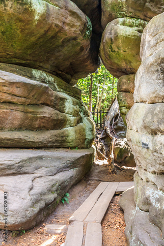 Obraz na płótnie Tourist trail in Errant Rocks (Błędne Skały) through a picturesque labyrinth (rock city) in the Central Sudetes in the Stolowe Mountains (Poland) w salonie