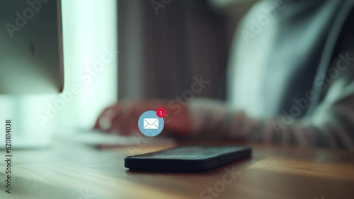 Smart phone mobile receiving mail message, email notification, Woman employee use mobile phone after receiving an email message while sitting at work desk.