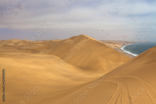paragliding in the desert dunes near Walvis bay in Namibia
