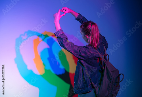 Photo session with a play of triple lights for a young girl dressed in a jean jacket and backpack