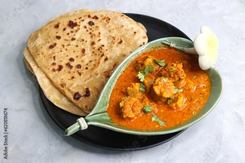 Rajasthani Gatta Curry or Besan Ke Gatte Ki Sabzi. Gatte are gram flour roundels or chickpea flour dumplings are cooked in a spicy, tangy yogurt based curry. delicacy of Rajasthan, India. copy space.