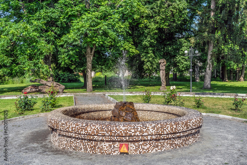 Fountain in the garden near Manor of the Nadarzhynsky-Holitsyns in Trostyanets, Sumy Oblast, Ukraine. Decoration of the city park near the Koenig Palace on a sunny summer day