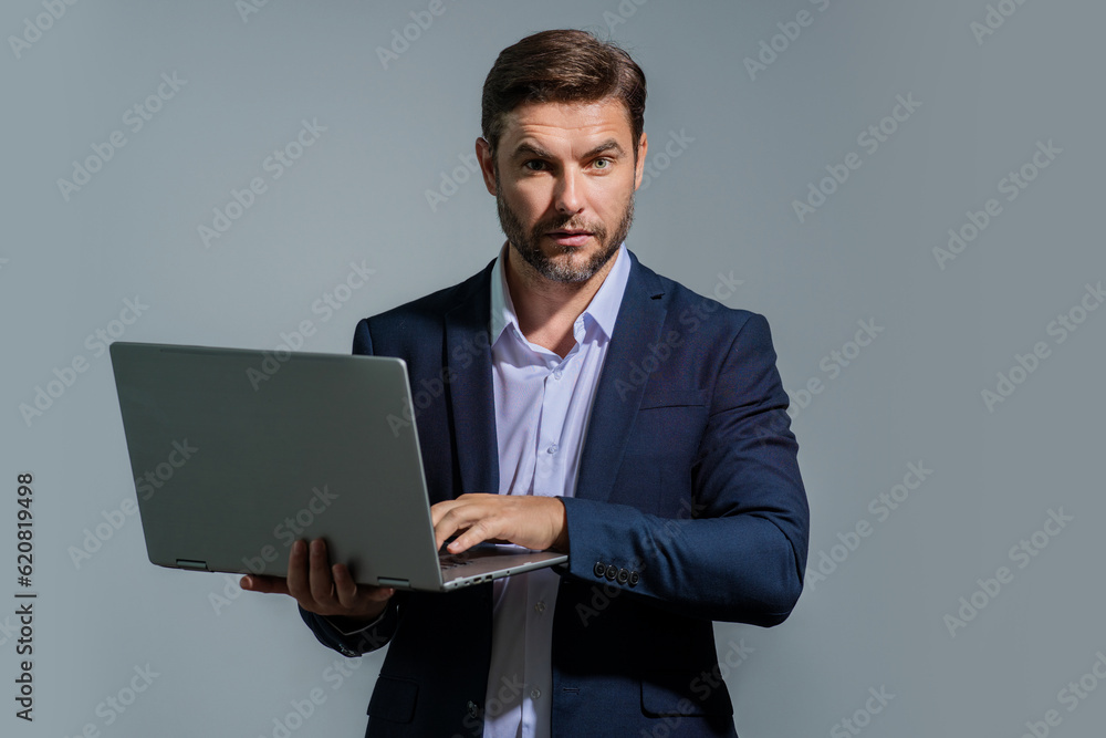 Freelancer man working on laptop in studio. Man freelancer checking laptop. Serious freelancer writing text on laptop. Male freelancer employee using laptop. Freelance and business. Freelancer man working on laptop in studio. Man freelancer checking laptop. Serious freelancer writing text on laptop. Male freelancer employee using laptop. Freelance and business.